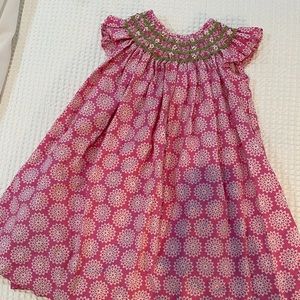 Smocked floral Bibb. GUC. Geometric pattern. Pink. Green. White.